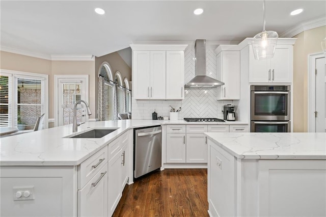 997 Thousand Oaks Bnd NW, Kennesaw, GA 30152 - kitchen featuring stainless steel appliances, wall chimney exhaust hood, a sink, white cabinetry, and recessed lighting
