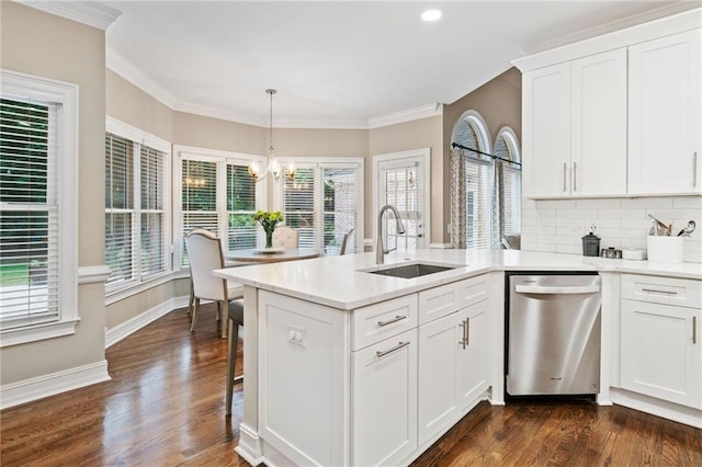 997 Thousand Oaks Bnd NW, Kennesaw, GA 30152 - kitchen with stainless steel dishwasher, a sink, a chandelier, a peninsula, and white cabinetry
