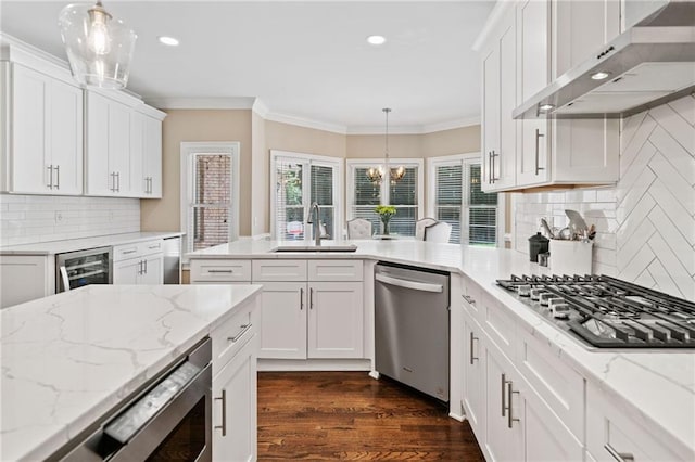 997 Thousand Oaks Bnd NW, Kennesaw, GA 30152 - kitchen featuring stainless steel appliances, a sink, wall chimney exhaust hood, wine cooler, and white cabinetry