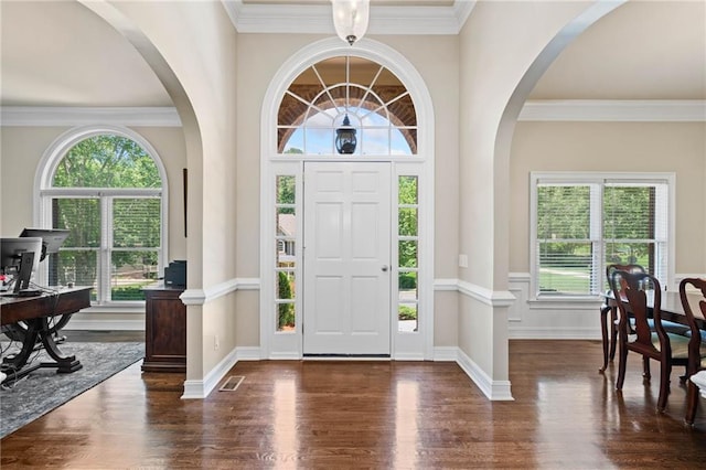 997 Thousand Oaks Bnd NW, Kennesaw, GA 30152 - foyer entrance with healthy amount of natural light, wood finished floors, arched walkways, and ornamental molding
