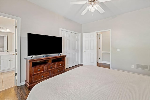 997 Thousand Oaks Bnd NW, Kennesaw, GA 30152 - bedroom featuring a closet, wood finished floors, ensuite bath, ceiling fan, and baseboards