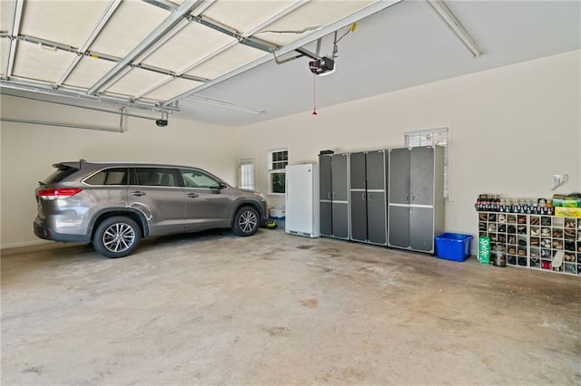997 Thousand Oaks Bnd NW, Kennesaw, GA 30152 - garage with freestanding refrigerator and a garage door opener