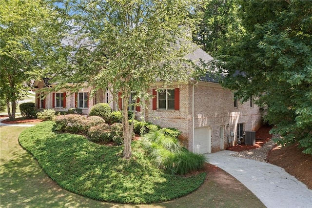 997 Thousand Oaks Bnd NW, Kennesaw, GA 30152 - view of property hidden behind natural elements featuring brick siding, concrete driveway, an attached garage, and cooling unit