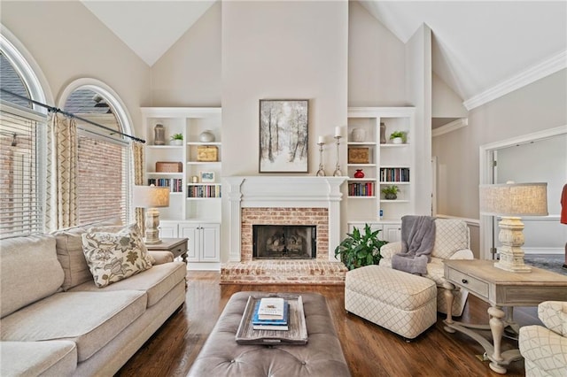 997 Thousand Oaks Bnd NW, Kennesaw, GA 30152 - living room with high vaulted ceiling, wood finished floors, built in features, a brick fireplace, and crown molding