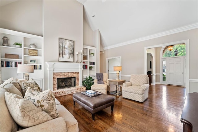 997 Thousand Oaks Bnd NW, Kennesaw, GA 30152 - living room featuring high vaulted ceiling, wood finished floors, built in shelves, baseboards, and a fireplace