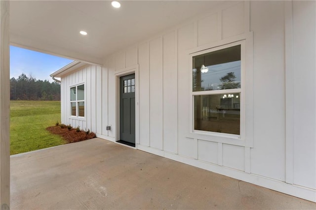 property entrance with a patio and a yard