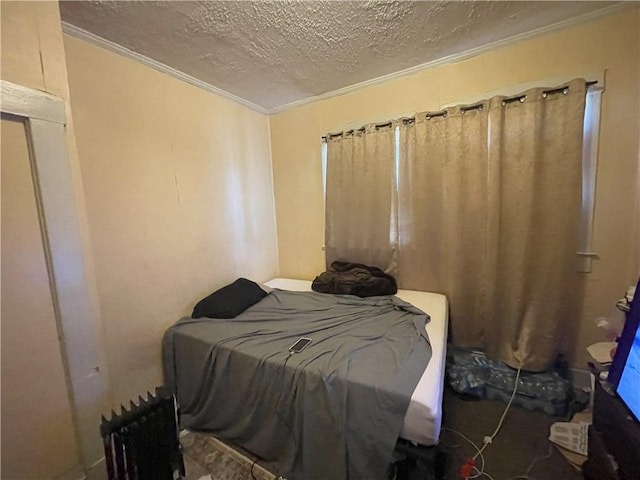 bedroom featuring a textured ceiling and crown molding