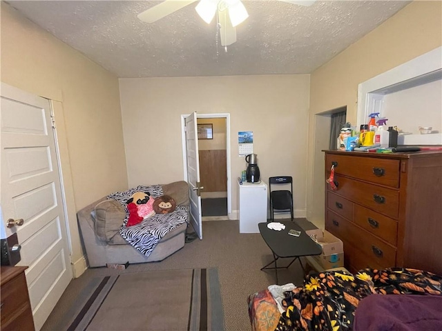 bedroom with ceiling fan, carpet, baseboards, and a textured ceiling