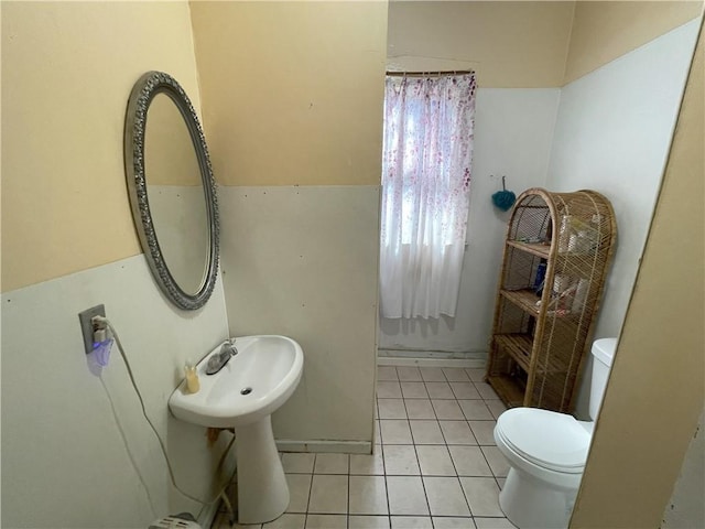 bathroom with toilet and tile patterned flooring