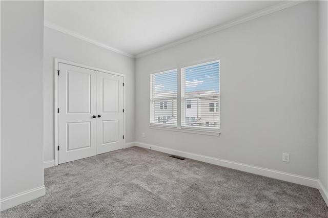 2631 Creekside Dr NW, Atlanta, GA 30318 - unfurnished bedroom featuring carpet, ornamental molding, baseboards, and a closet