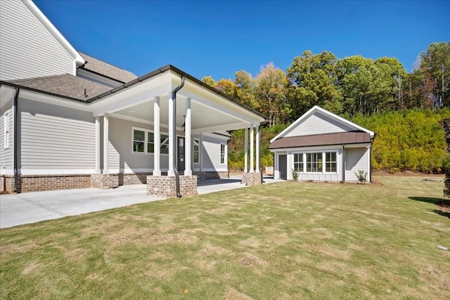 rear view of property with a yard and central air condition unit