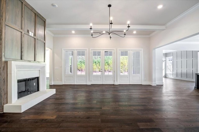 unfurnished living room featuring a wealth of natural light, a fireplace, and dark wood-type flooring