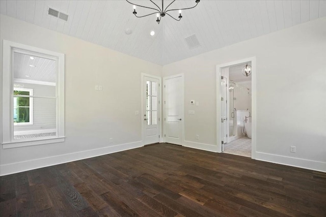 spare room with wooden ceiling, visible vents, baseboards, and wood finished floors