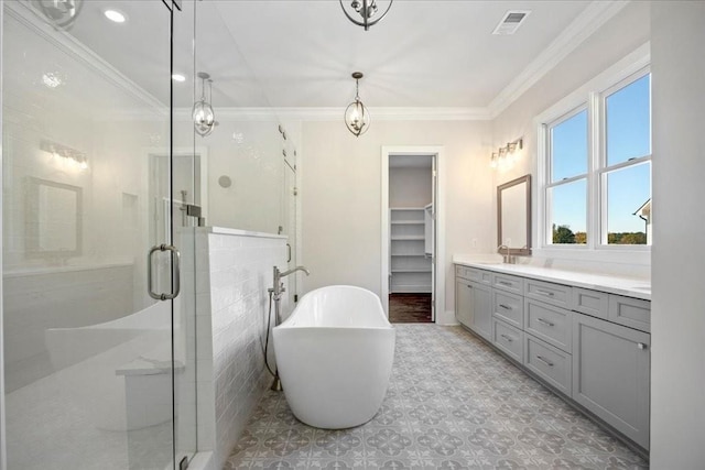 bathroom with a walk in closet, crown molding, visible vents, vanity, and a shower stall