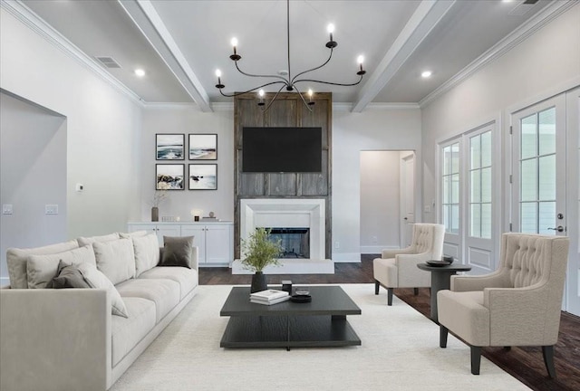 living room featuring crown molding, a large fireplace, beamed ceiling, and wood finished floors