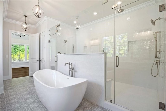 full bath featuring a stall shower, a freestanding bath, and crown molding