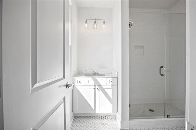 bathroom with a shower stall and vanity