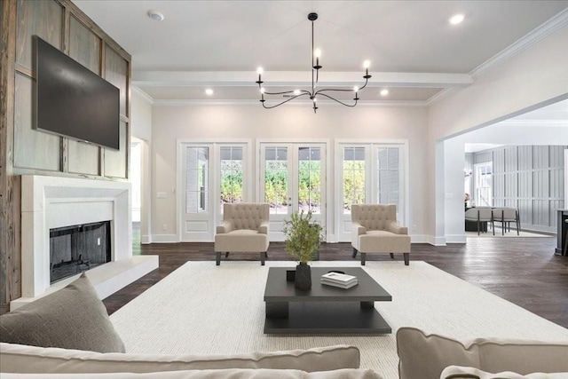 living area featuring a healthy amount of sunlight, baseboards, a fireplace with raised hearth, and dark wood finished floors