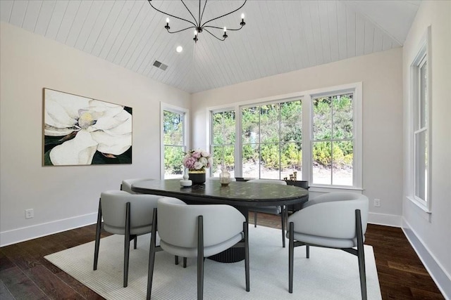 dining room with lofted ceiling, baseboards, visible vents, and a notable chandelier