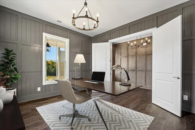 office area with dark wood-style floors, visible vents, baseboards, and an inviting chandelier