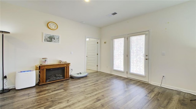 unfurnished living room featuring hardwood / wood-style flooring