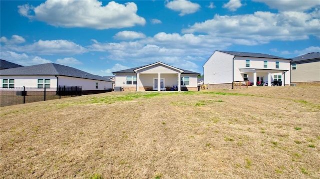 rear view of house featuring a yard