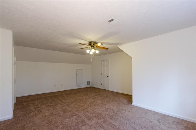 additional living space with ceiling fan, vaulted ceiling, and carpet flooring