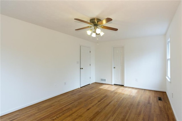 empty room with ceiling fan and hardwood / wood-style floors