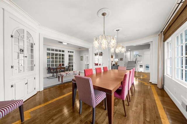 dining space featuring baseboards, a chandelier, stairs, ornamental molding, and dark wood-style flooring