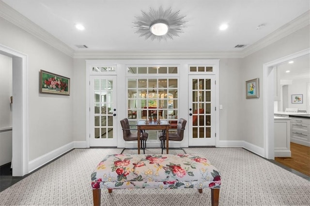 sitting room featuring crown molding, french doors, visible vents, and baseboards