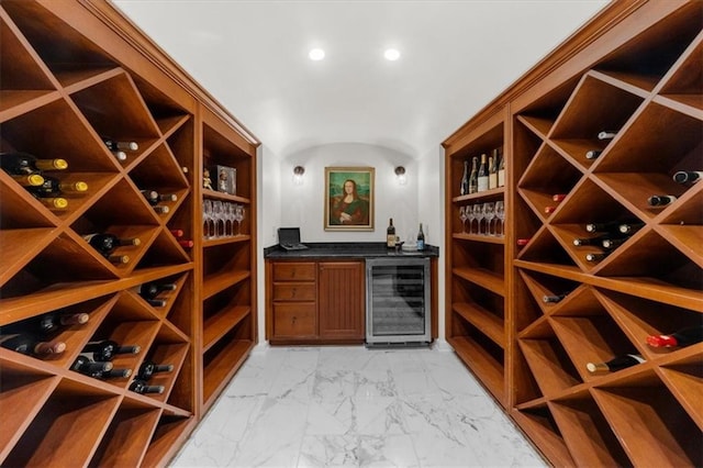 wine room with beverage cooler and marble finish floor