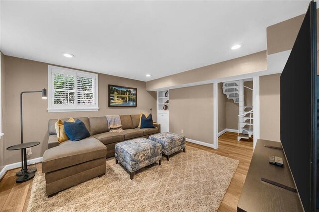 living room with recessed lighting, baseboards, and wood finished floors