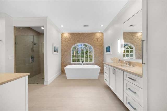 full bath with visible vents, a shower stall, recessed lighting, a freestanding tub, and vanity
