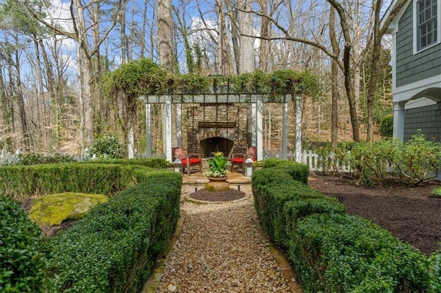 view of yard featuring an outdoor stone fireplace
