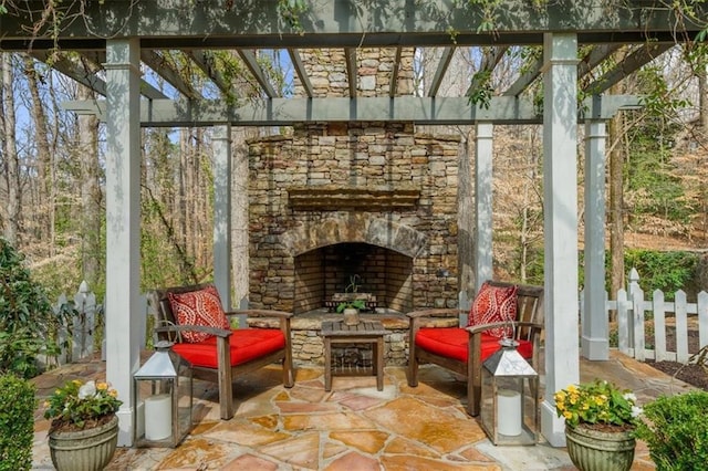 view of patio / terrace featuring an outdoor stone fireplace and a pergola
