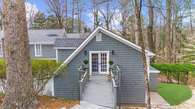 view of front of house with french doors and roof with shingles