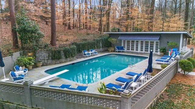 view of swimming pool featuring a patio area, a fenced in pool, french doors, and fence