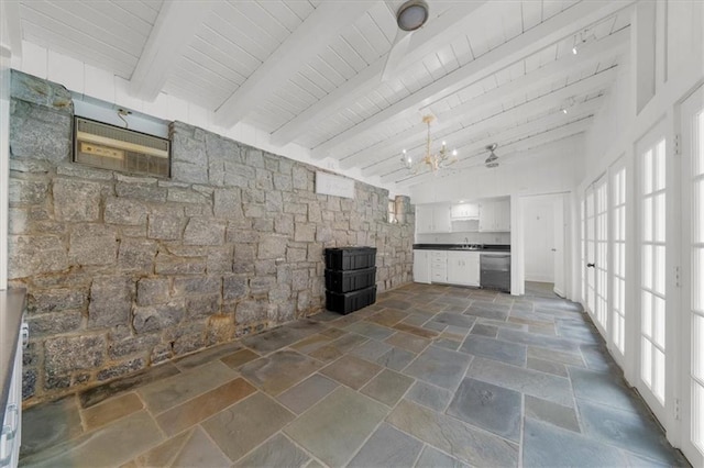 unfurnished living room featuring beam ceiling, wood ceiling, and stone tile flooring