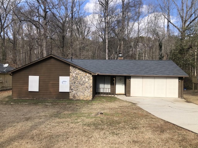 single story home with a garage and a front lawn