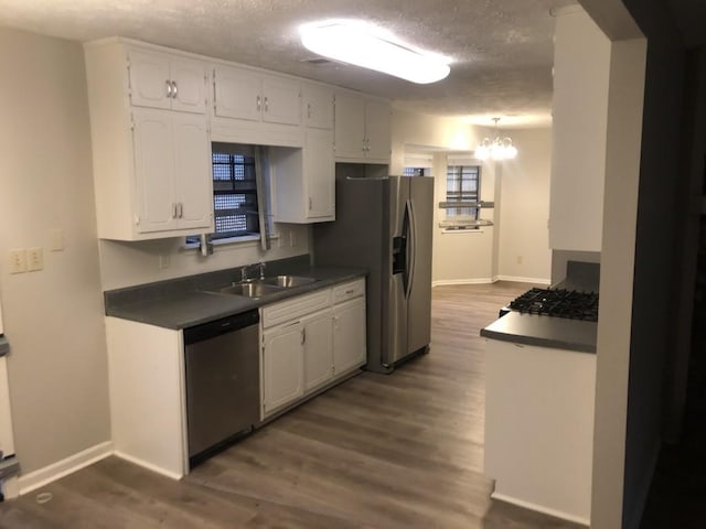 kitchen featuring white cabinetry, sink, dark wood-type flooring, and appliances with stainless steel finishes