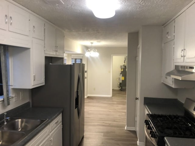 kitchen featuring sink, stainless steel gas stove, white cabinetry, light hardwood / wood-style flooring, and a textured ceiling