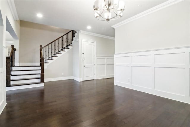 unfurnished living room with a chandelier, dark hardwood / wood-style flooring, and crown molding