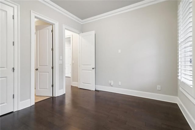 unfurnished bedroom with crown molding and dark wood-type flooring