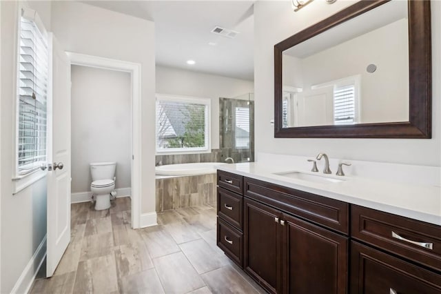 full bathroom with vanity, toilet, and independent shower and bath