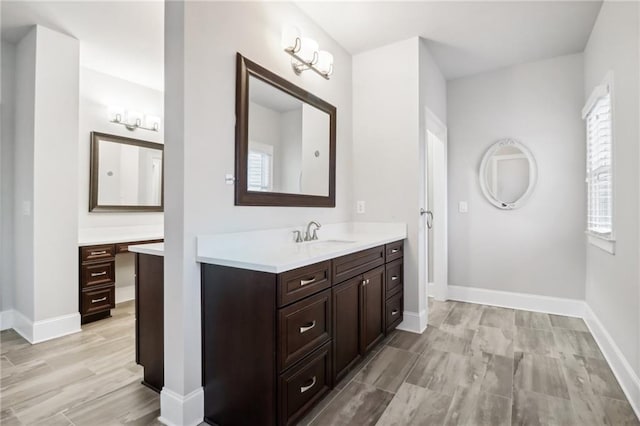 bathroom featuring wood-type flooring, vanity, and plenty of natural light