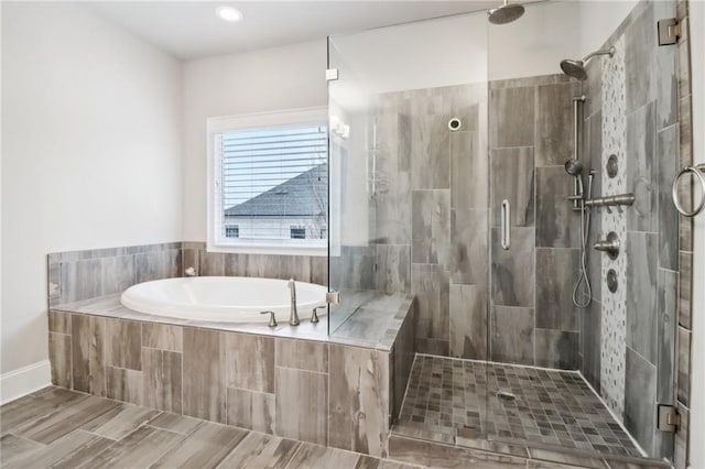 bathroom featuring shower with separate bathtub