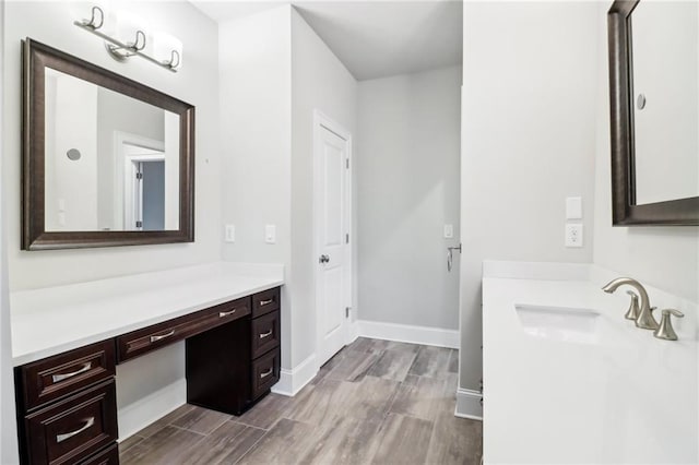 bathroom with hardwood / wood-style floors and vanity