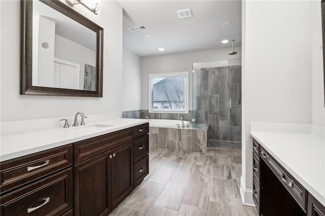 bathroom with vanity and plus walk in shower