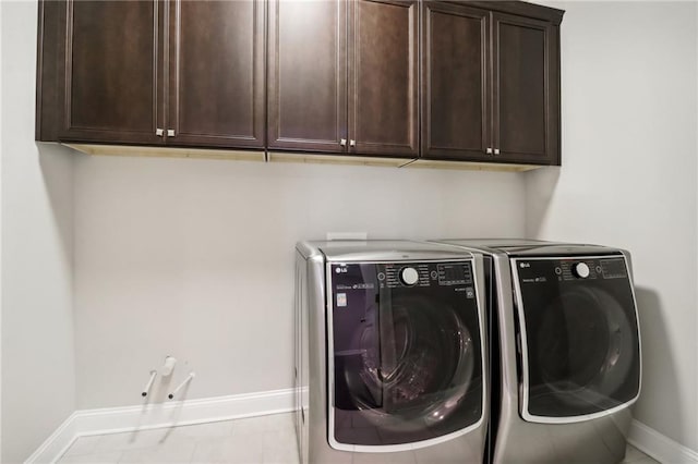 laundry area featuring washer and dryer and cabinets