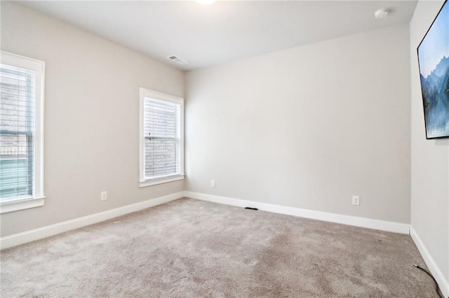 empty room featuring light carpet and a healthy amount of sunlight